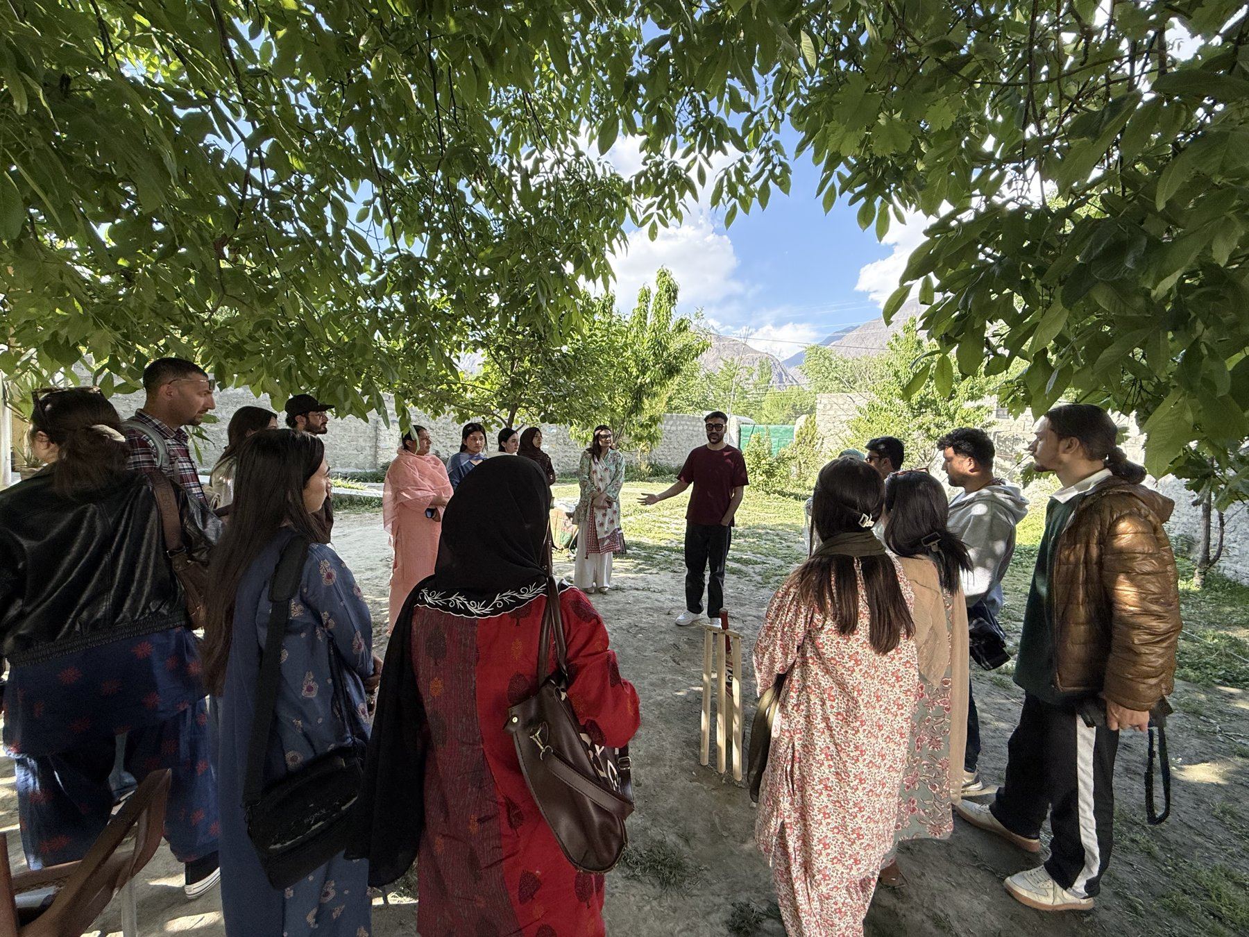 Trainee storytellers on a field visit under walnut trees in Gilgit-Baltistan