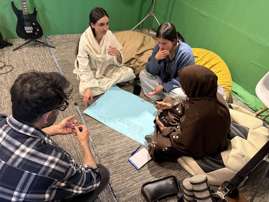 Trainees working on a story outline together